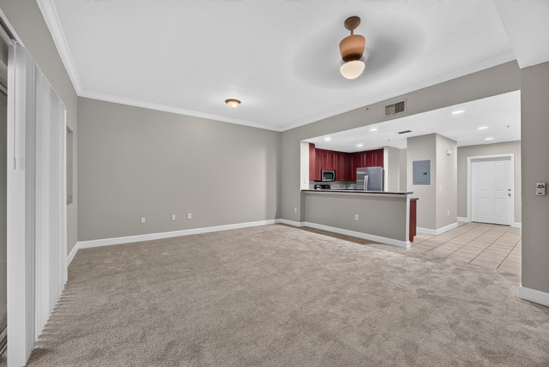 Living room open to kitchen with carpet flooring at 9745 Touchton Rd, Jacksonville, FL 32246
