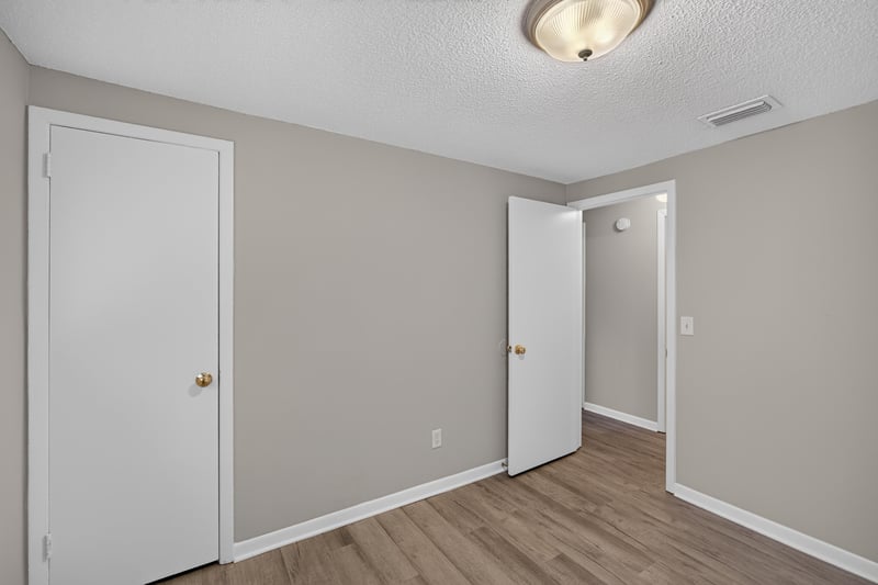 Hallway with two doors and wood-look flooring at 1435 Undine Ave, Jacksonville, FL