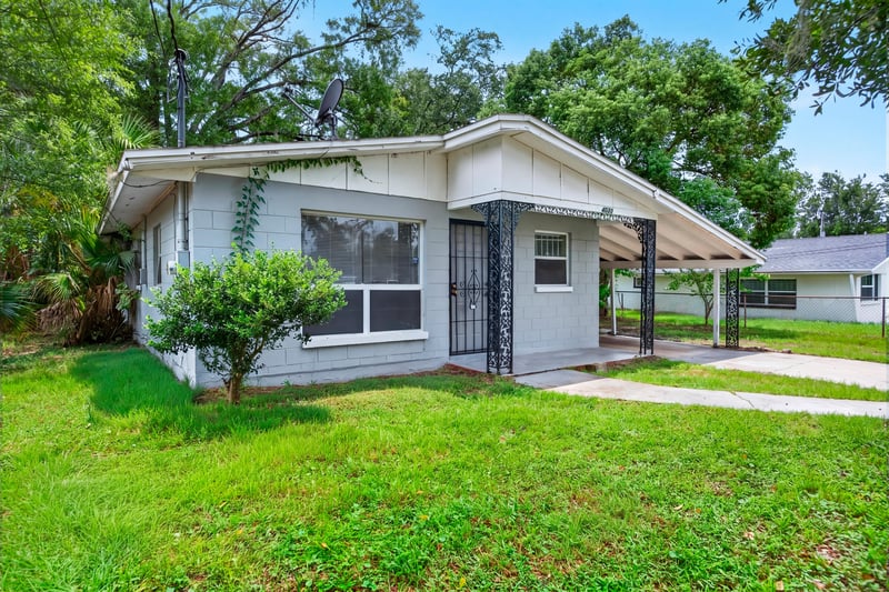 Front exterior view of light blue block home at 4030 Leonard Cir W, Jacksonville, FL 32209