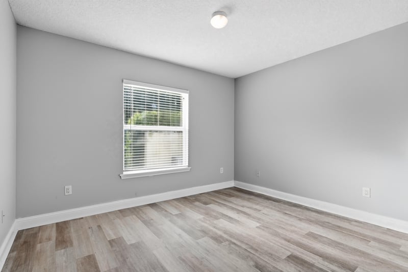 Bedroom with wood-look flooring and natural light at 14187 Big Spring St, Jacksonville, FL 32258