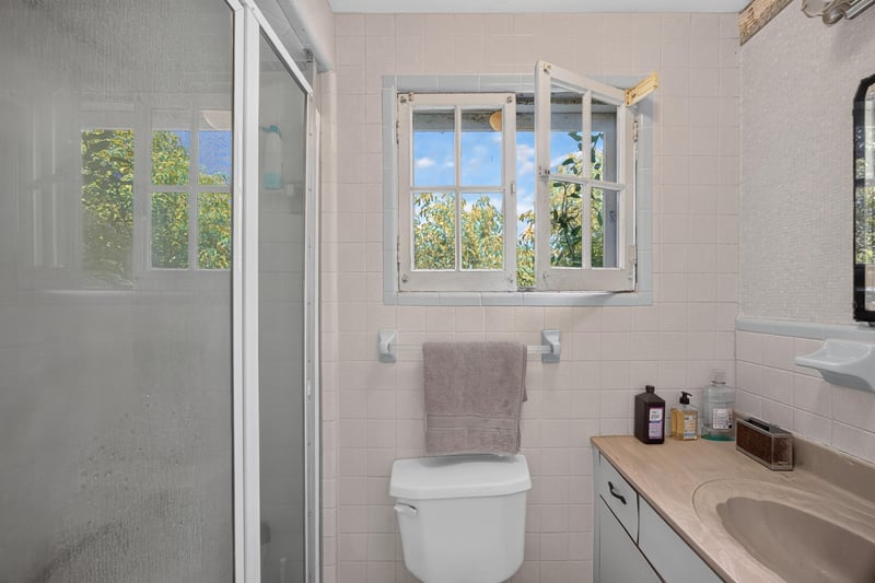 Bathroom with shower stall and toilet at 1173 US-17, Satsuma, FL 32189