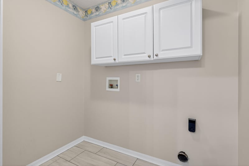 Laundry area with cabinets at 1648 Glen Laurel Dr, Middleburg, FL 32068