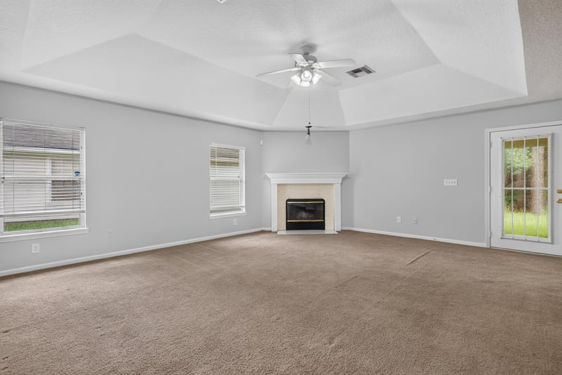 Living room with fireplace and carpet flooring at 11669 Collins Creek Dr, Jacksonville, FL 32258