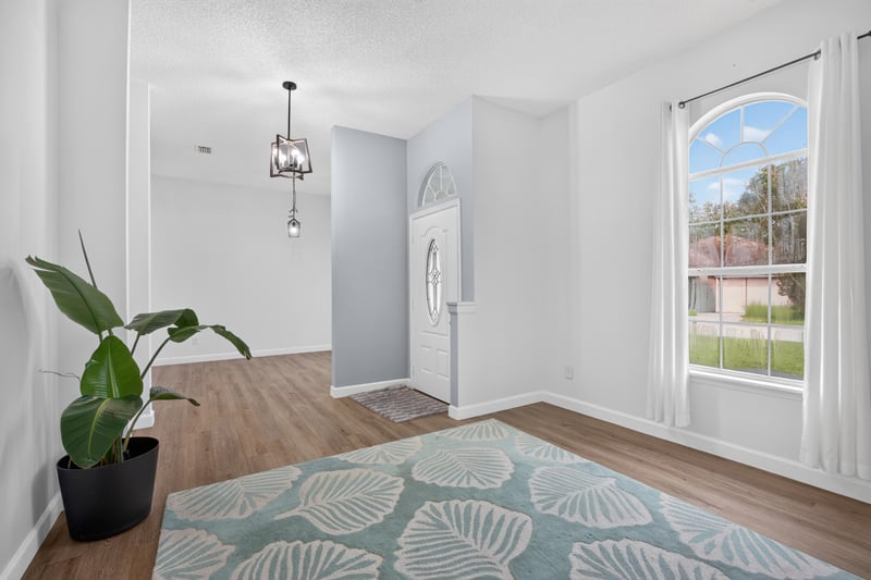 Room with large window and wood floors at 8921 Needlepoint Pl, Jacksonville, FL 32244