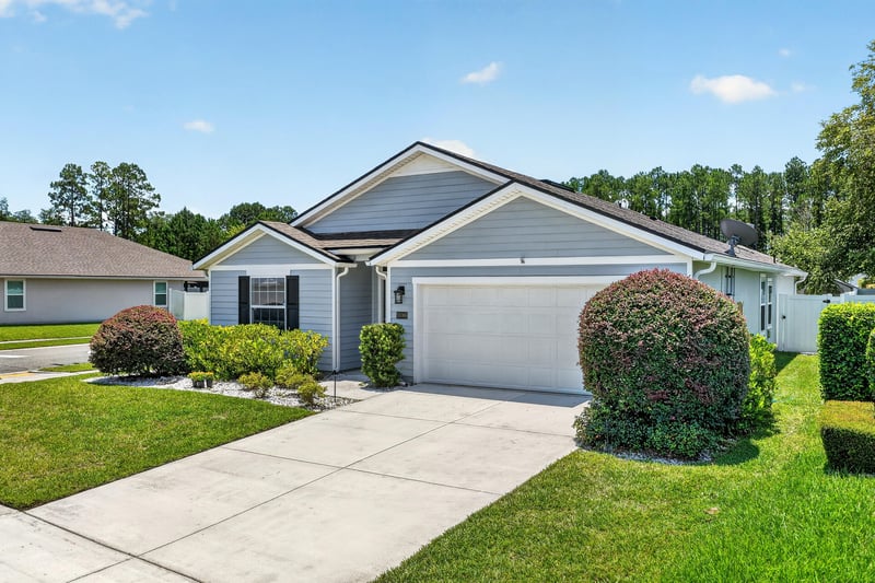 Front exterior view across the driveway and lawn at 10066 Andean Fox Dr, Jacksonville, FL 32222
