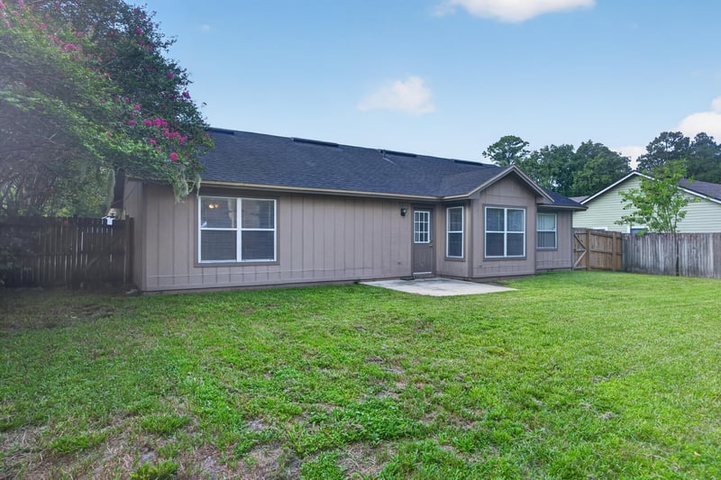 Rear exterior with patio and fenced yard at 6646 Shiloh Creek Dr