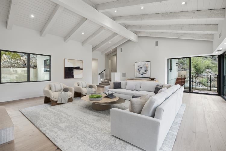 Family room with a beamed ceiling, virtually staged