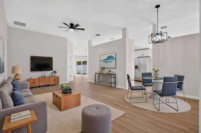 Living room, virtually staged with sofa and TV at 224 Pine Arbor Cir, St. Augustine, FL 32084