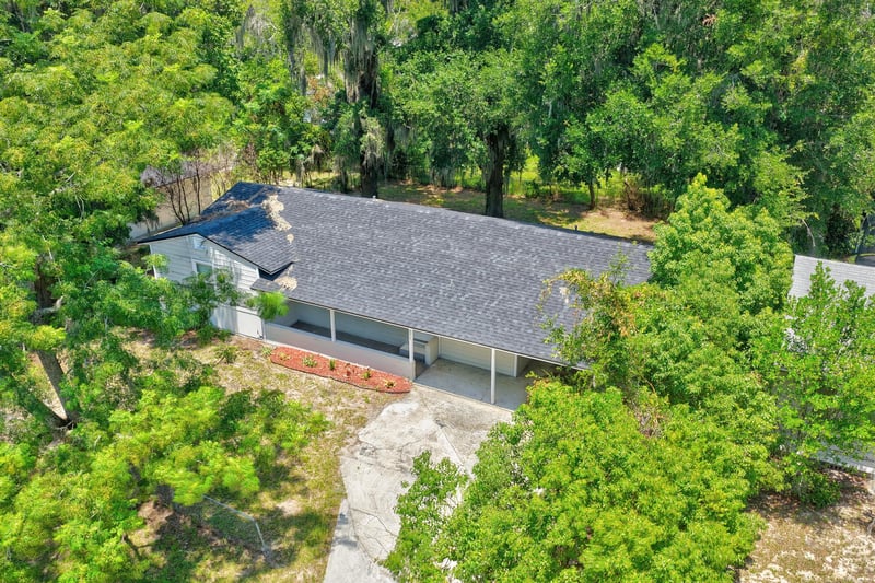 Drone view of rooftop and tree-lined yard at 855 Cornwallis Dr, Jacksonville, FL