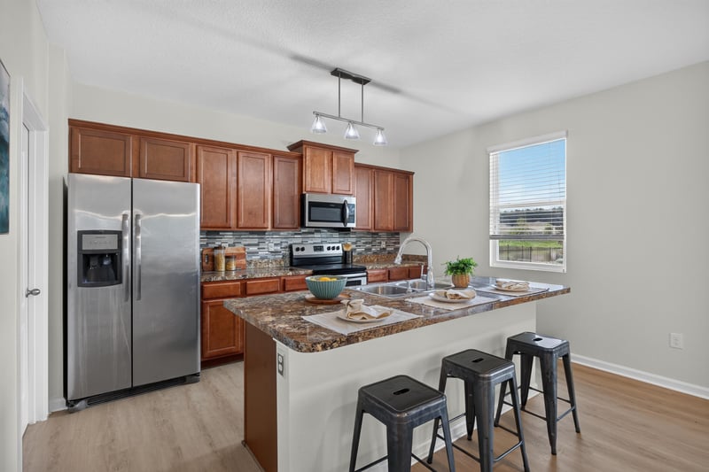 Kitchen with stainless appliances and granite island at 6830 Hanford St, Jacksonville, FL 32219