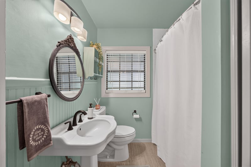 Bathroom with green tile and pedestal sink at 5843 Ovella Rd, Jacksonville, FL 32244