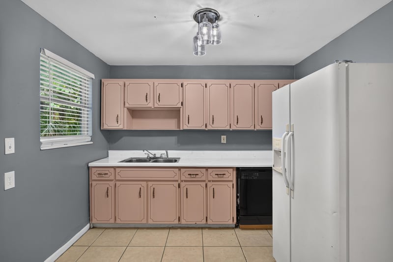 Kitchen with mauve cabinets and white refrigerator at 6745 Jack Horner Ln, Jacksonville, FL 32210