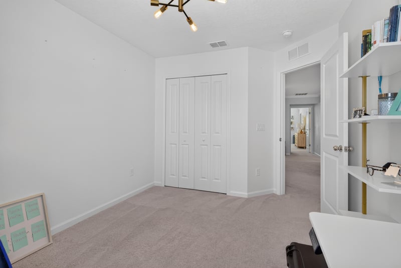 Empty secondary bedroom with closet door at 1186 Beach Dune Dr, Jacksonville, FL 32233