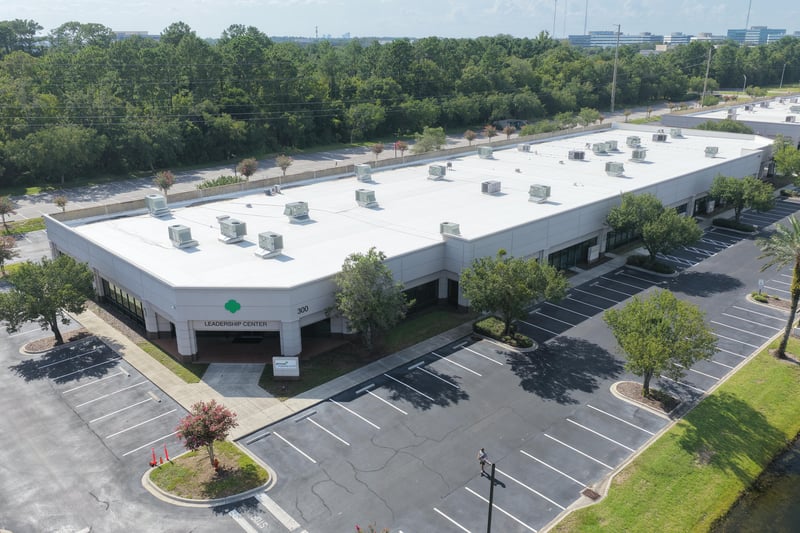 Aerial view of a building roofline and parking lot at 10550 Deerwood Park Blvd, Jacksonville, FL 32256