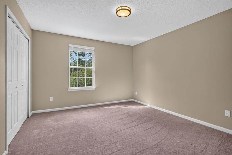 Bedroom with carpet, window and closet at 13685 Goodson Pl, Jacksonville, FL 32226