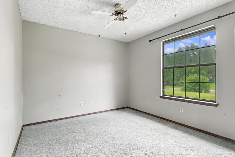Bedroom with neutral walls and large window at 2915 Trenton Ct, Orange Park, FL