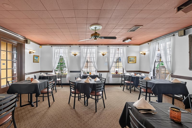 Dining room with windows and a ceiling fan at 115 Cordova St, St. Augustine, FL
