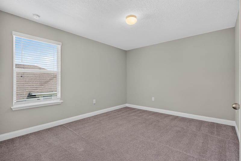 Carpeted bedroom with closet door at 2580 Cold Stream Ln, Green Cove Springs, FL 32043