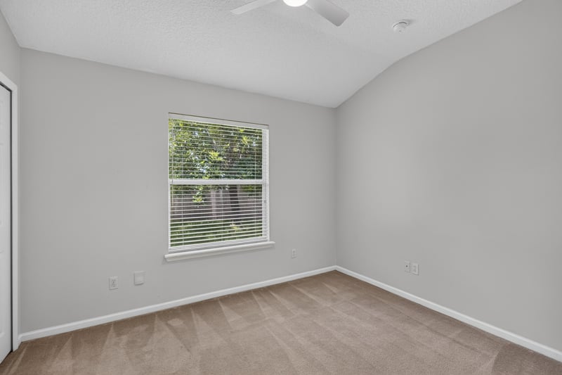 Bedroom with window and carpet flooring at 2480 Ridge Will Dr, Jacksonville, FL 32246