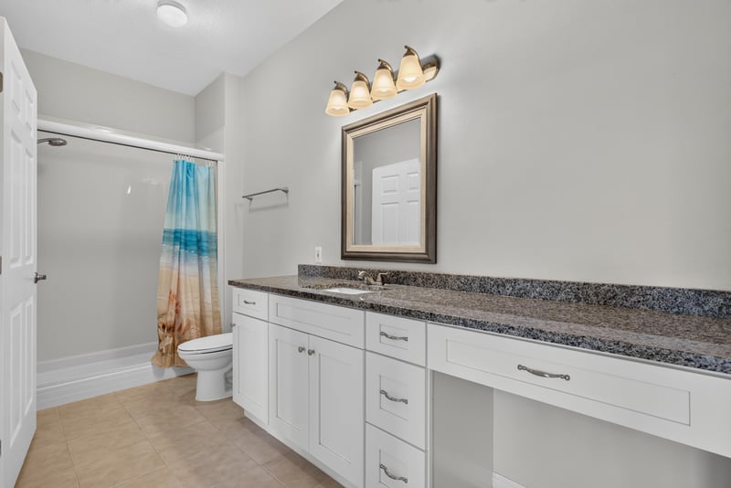 Bathroom with granite vanity and shower at 7990 Baymeadows Rd E #404, Jacksonville, FL 32256