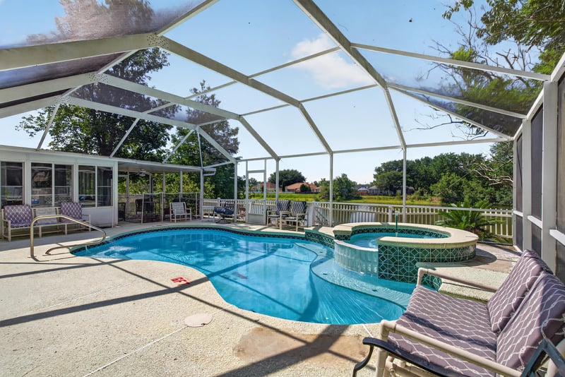 Pool and spa under screened enclosure at 8680 Bandera Cir S, Jacksonville, FL 32244
