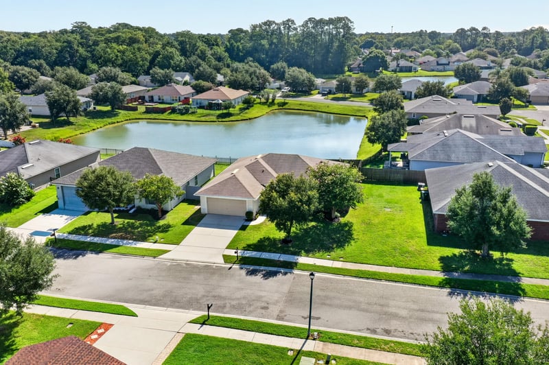 Aerial view of the home among neighborhood rooftops at 7545 Lirope St, Jacksonville, FL 32244