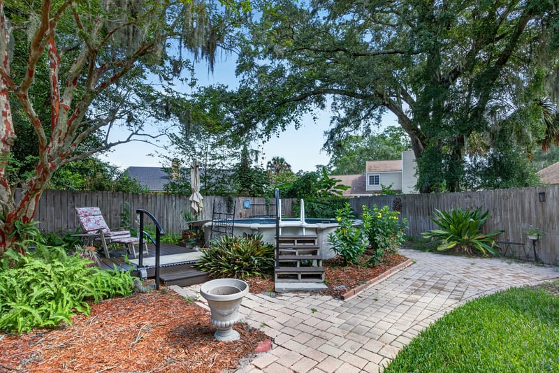 Backyard with mature trees and patio at 4837 Pareja Ct, Jacksonville, FL 32225