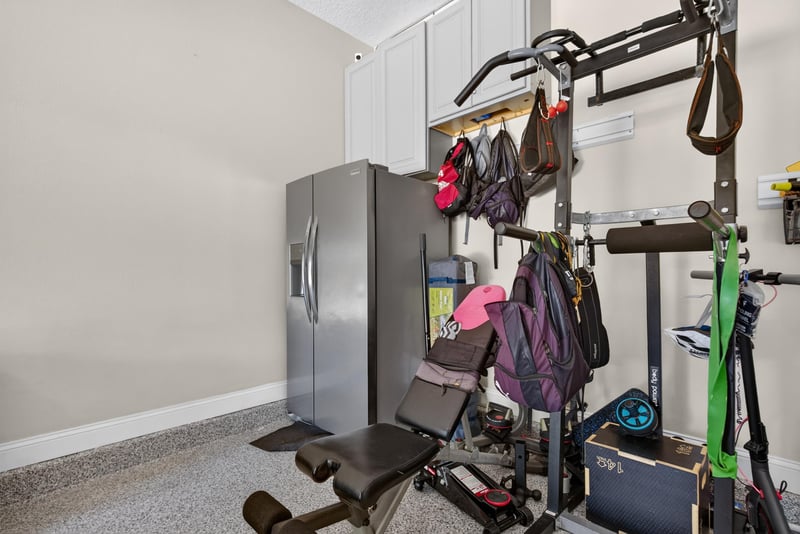 Garage area set up with home gym equipment at 22 Azura Point