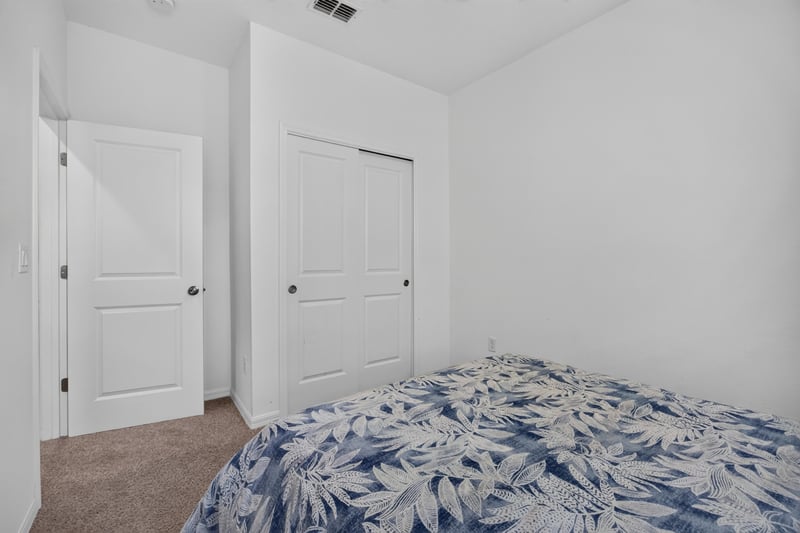 Bedroom with closet doors and patterned bedding at 339 Anthony Dr, Jacksonville, FL