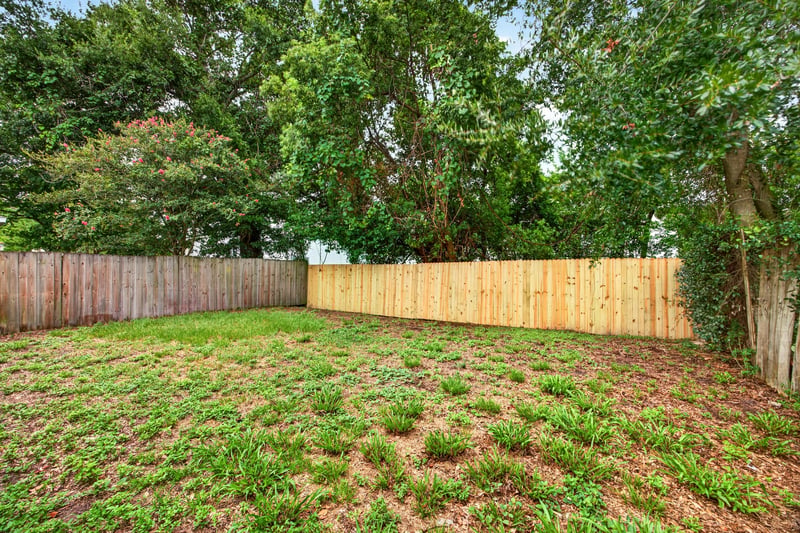 Backyard with grass and wood fence line at 7329 Lawn Tennis Ln, Jacksonville, FL