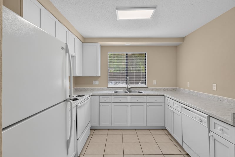 Kitchen with white cabinets and tile floor at 5811 Atlantic Blvd unit 47, Jacksonville, FL 32207