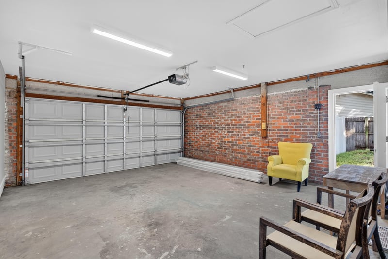 Garage interior with brick wall and overhead doors at 8453 Boysenberry Ln W, Jacksonville, FL