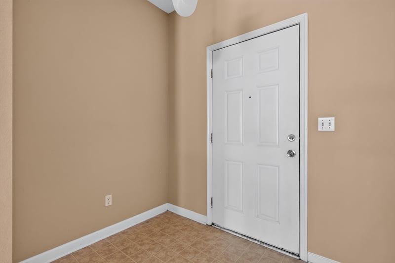 Entry foyer with tile floor and front door at 12359 Mangrove Forest Ct, Jacksonville, FL 32218