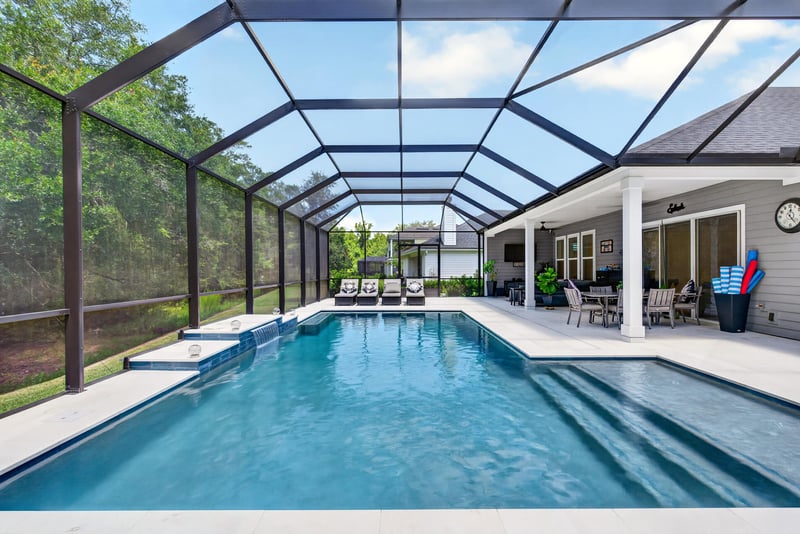 Pool and patio viewed under the screened enclosure at 785 Back Creek Dr, St. Augustine, FL 32092