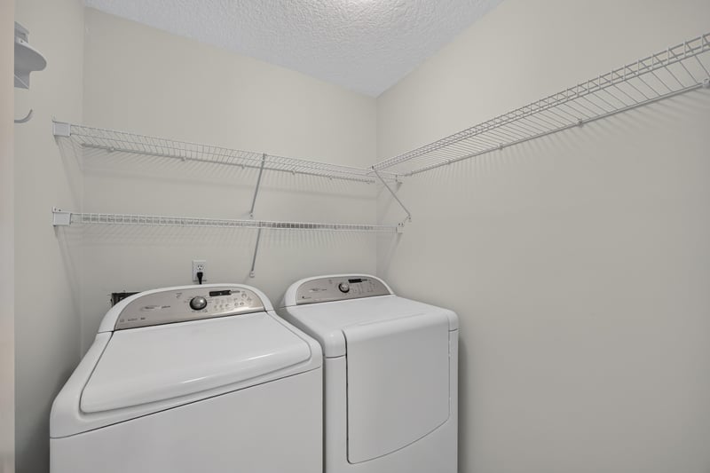 Laundry room with washer, dryer, and wire shelving at 2131 E Stone Creek Dr, Fleming Island, FL