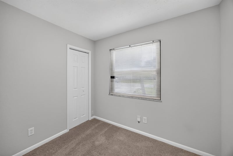Empty room with window and closet door at 7453 Jade Dr N, Jacksonville, FL 32210