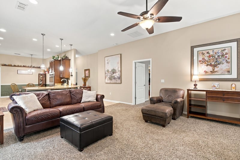 Living area with sofa and leather ottoman at 10923 Black Diamond Ct, Jacksonville, FL