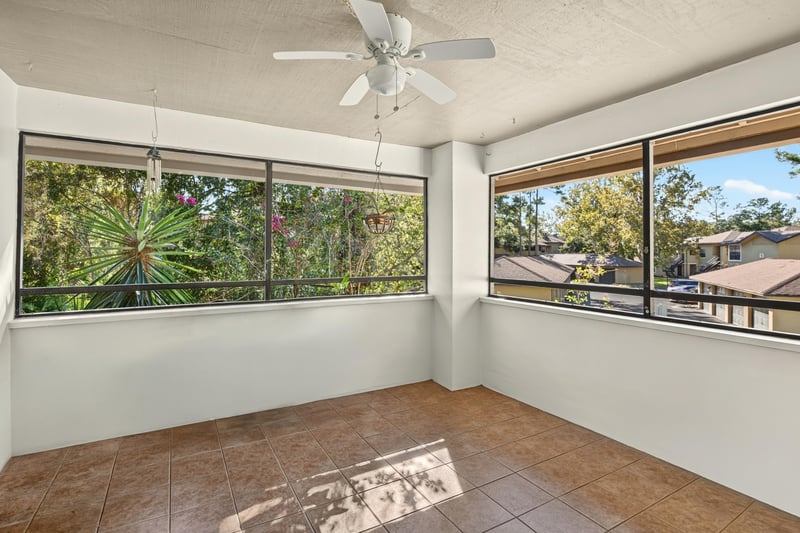 Screened porch with windows and tile flooring at 10150 Belle Rive Blvd, Jacksonville, FL