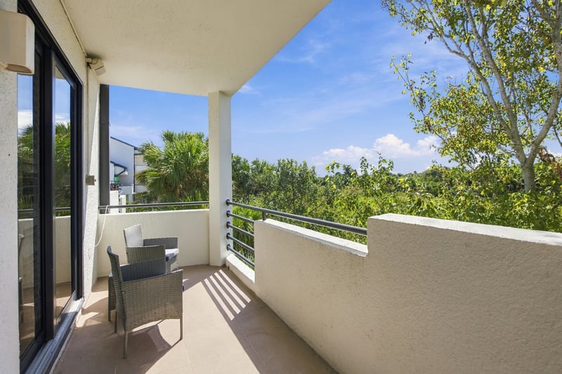 Balcony seating with tree views at 752 Spinnakers Reach Dr, Ponte Vedra Beach, FL 32082