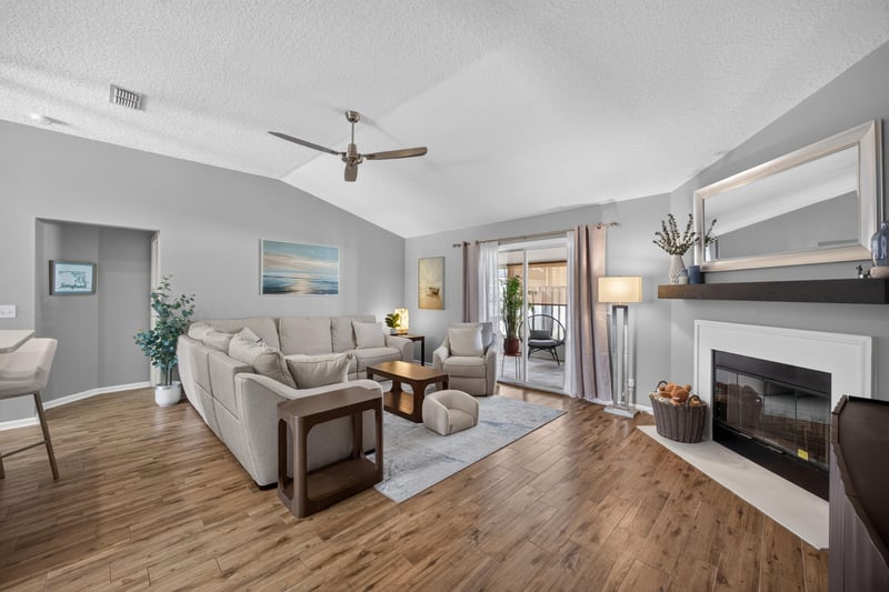 Living room with fireplace and sectional sofa at 12825 Kelsey Island Dr, Jacksonville, FL 32224