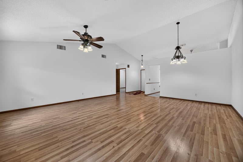 Open living space with wood flooring and two ceiling fans at 2460 San Sago Ln, Jacksonville, FL