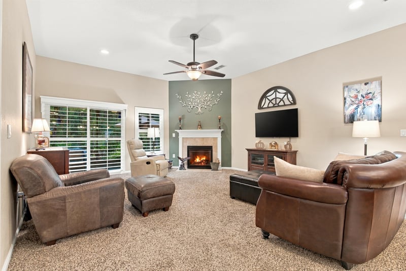 Family room with fireplace and leather chairs at 10923 Black Diamond Ct, Jacksonville, FL