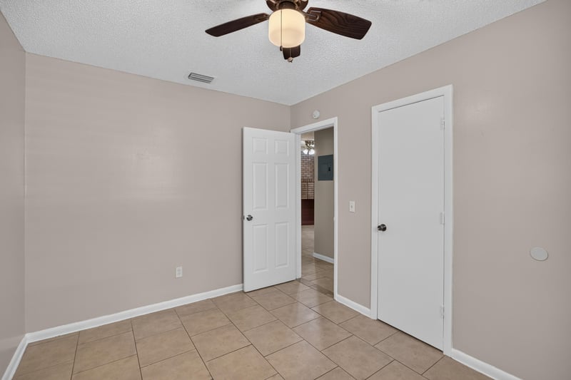 Hallway with multiple doors and tile floor at 8067 Parental Cir, Jacksonville, FL 32216