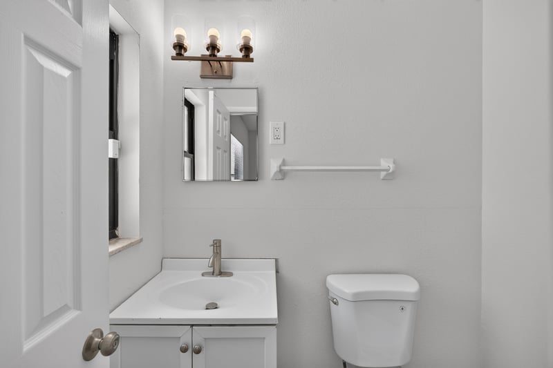 Bathroom with pedestal sink, toilet and grab bar at 7453 Jade Dr N, Jacksonville, FL 32210