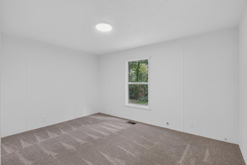 Bedroom with carpet and window at 55520 Jewel-Thomas Rd, Callahan, FL 32011