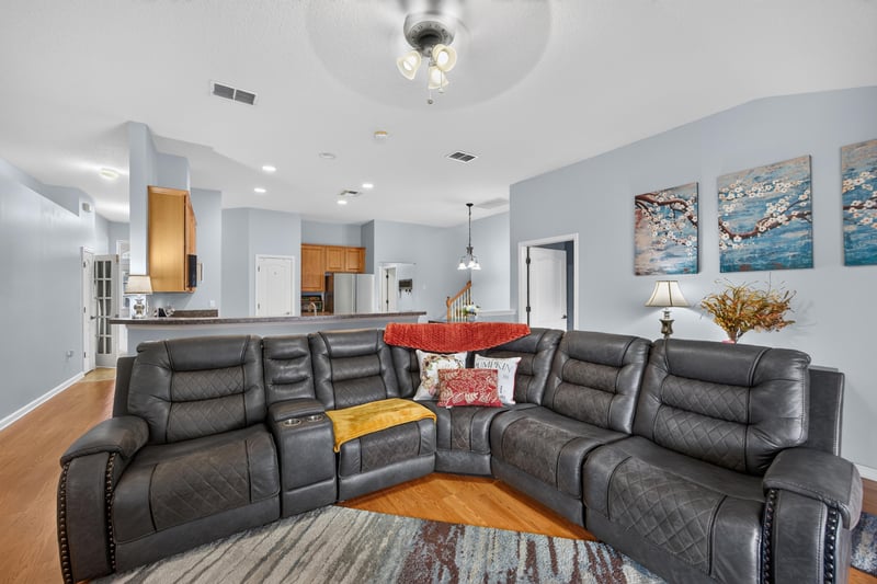 Leather sectional and area rug in family room at 3112 Silverado Cir, Green Cove Springs, FL 32043