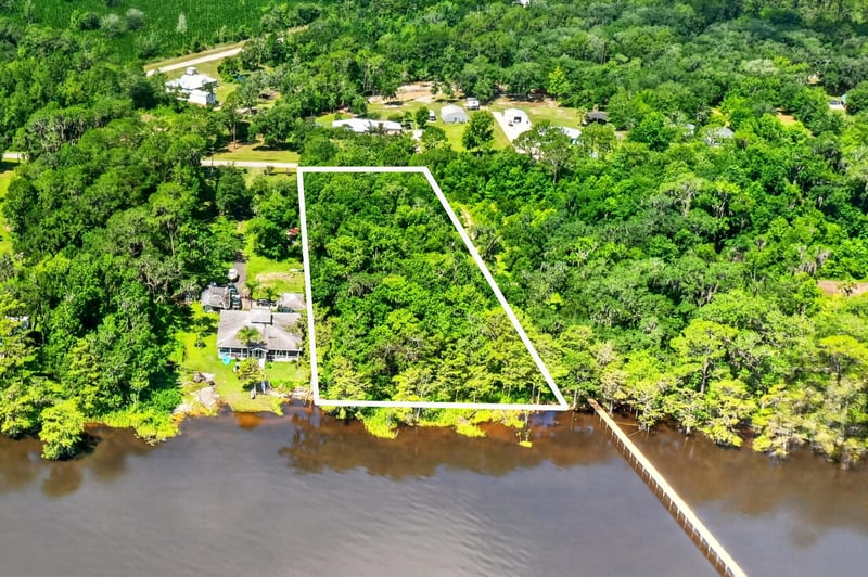 Aerial view of the property line marked in white along the riverbank at 110 River Shores Rd, Palatka, FL 32043