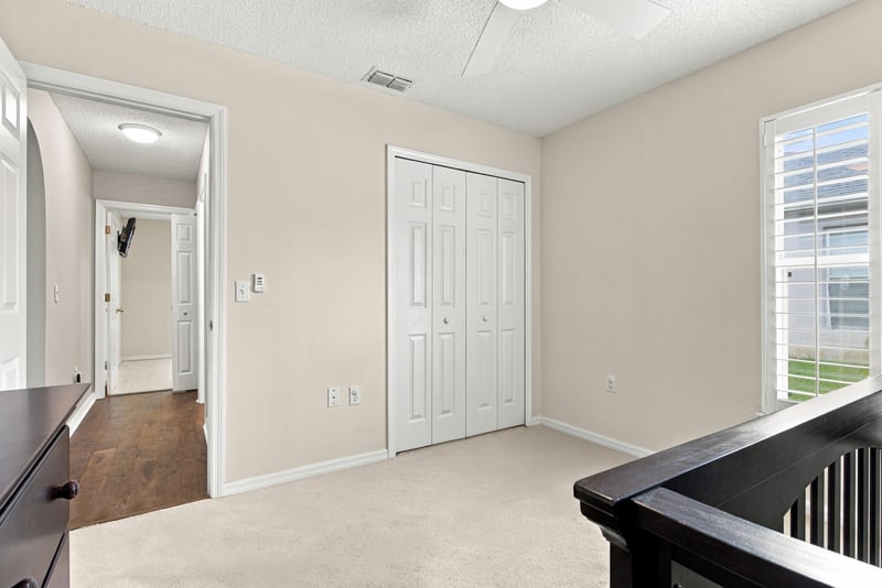 Hallway leading to bedroom with closet doors at 11197 Illford Dr