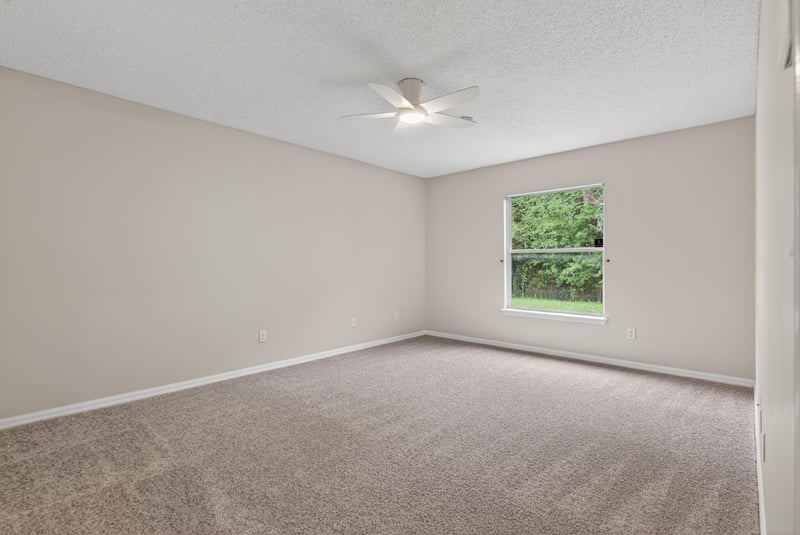 Bedroom with carpet, window and ceiling fan at 1648 Glen Laurel Dr, Middleburg, FL 32068