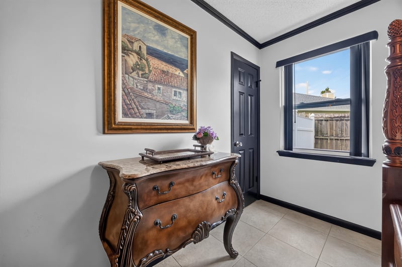 Bedroom with dresser and framed art at 6931 Cane Grass Ln E, Jacksonville, FL 32244